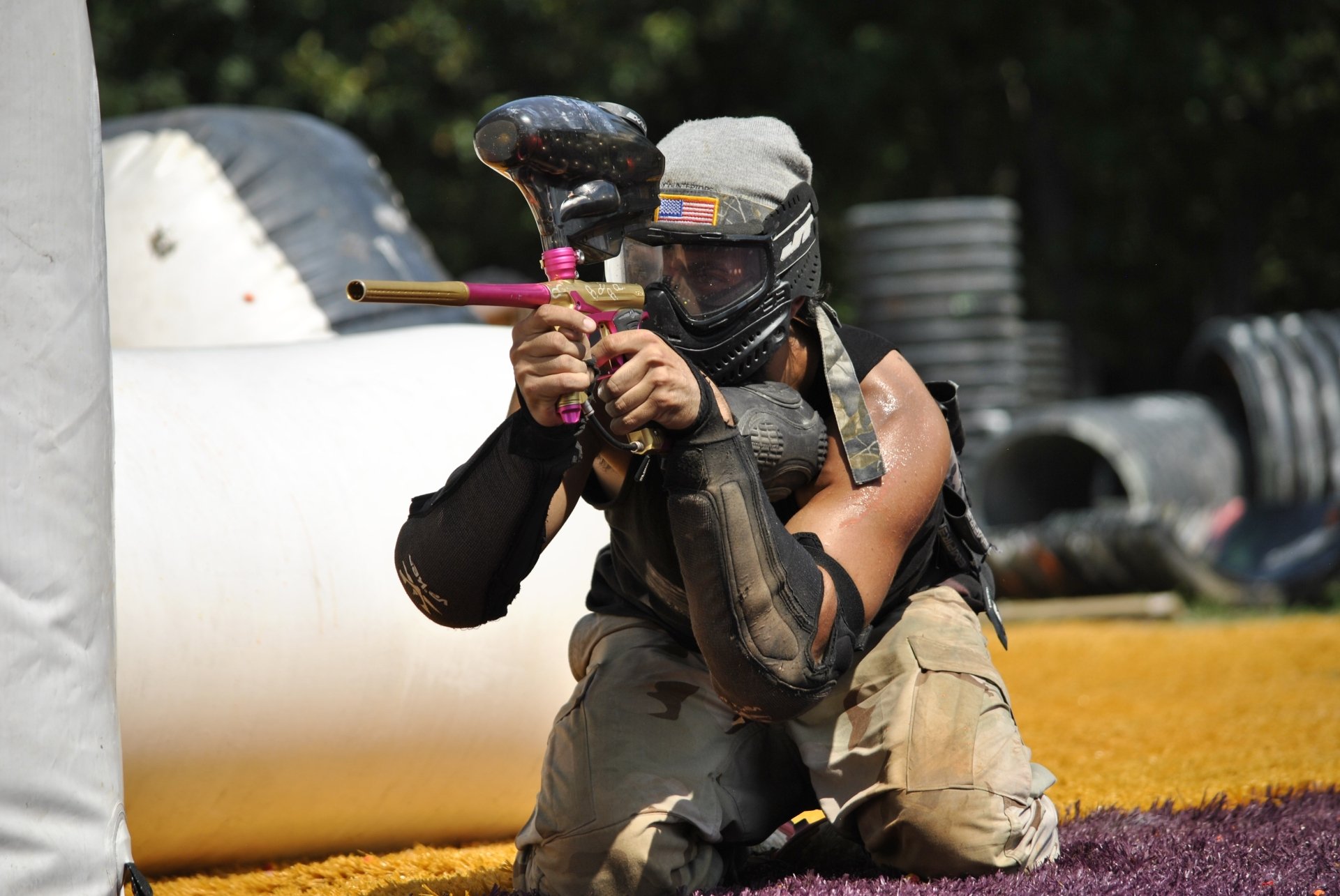 Paintball players taking cover behind bunkers